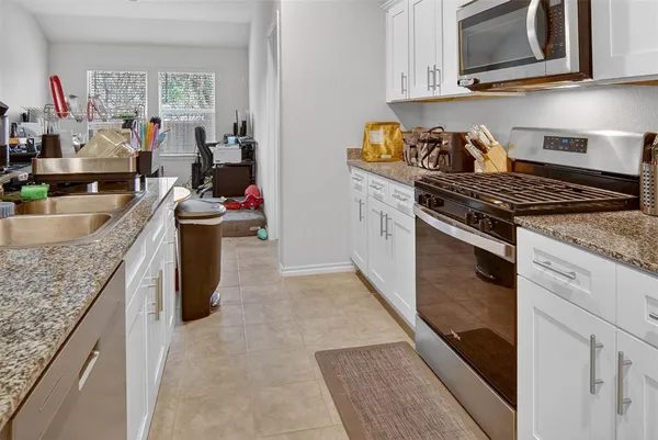 a kitchen with sink cabinets and utility