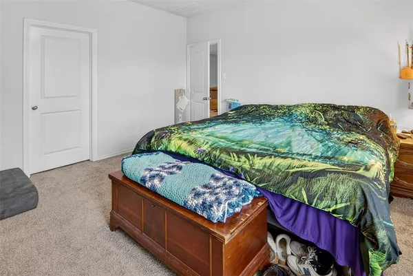 a bed sitting in a bedroom next to a window