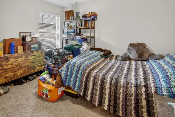 a bedroom with two beds and a book shelf