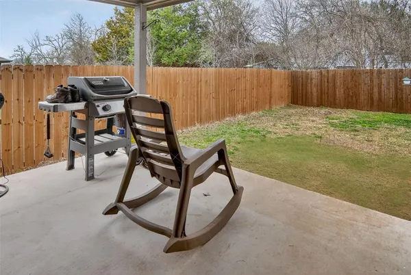 a view of a backyard with chairs