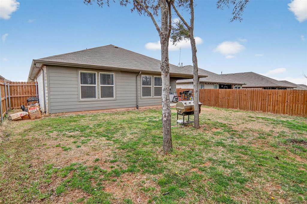 536 Bronze Circle East Springtown, TX 76082 - Photo 27 of 28 a backyard of a house with table and chairs