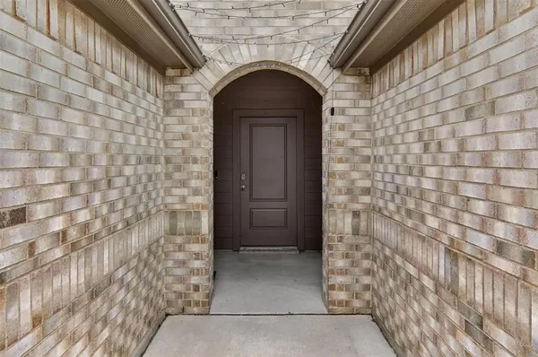 a front view of a house with a brick wall