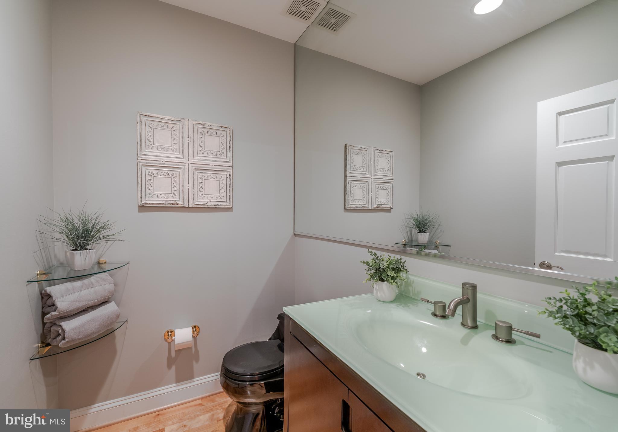 1715 Lancaster Street Baltimore, MD 21231 - Photo 11 of 68 a bathroom with a sink a toilet and mirror
