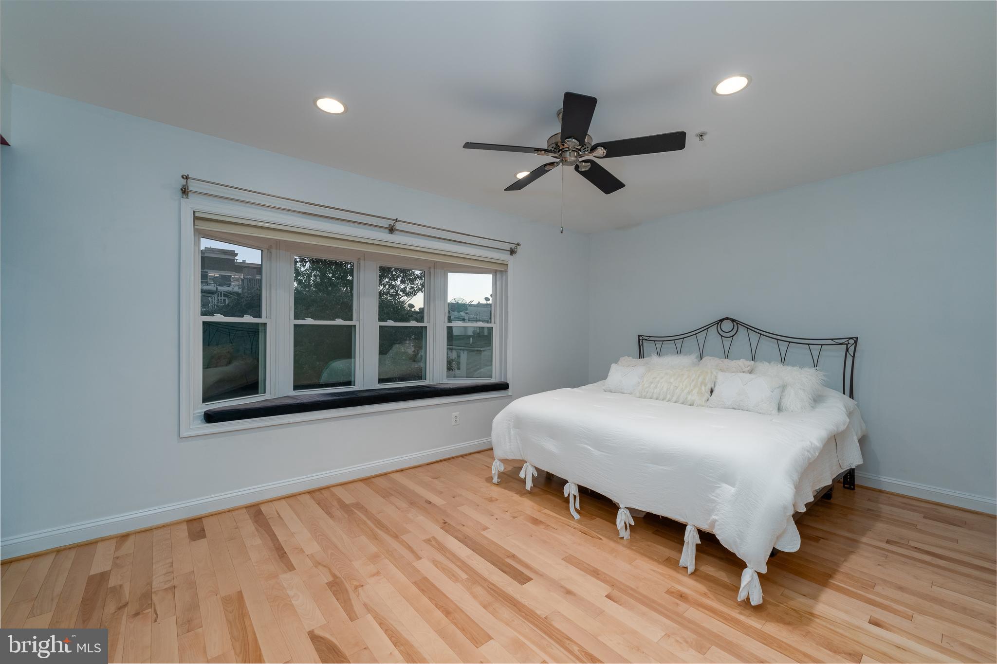 1715 Lancaster Street Baltimore, MD 21231 - Photo 17 of 68 a bedroom with a bed and wooden floor