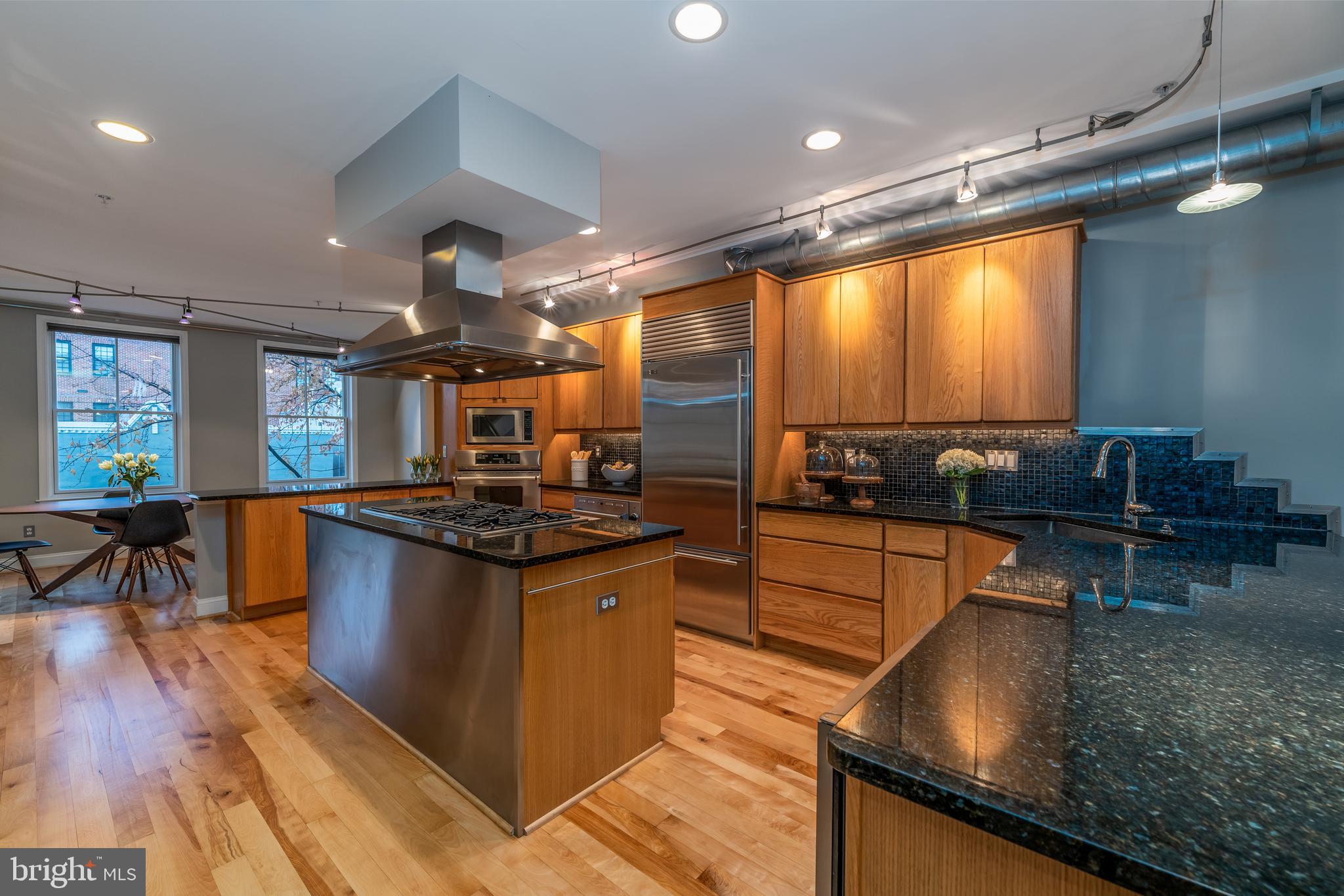 1715 Lancaster Street Baltimore, MD 21231 - Photo 3 of 68 a kitchen with stainless steel appliances granite countertop a stove and a sink