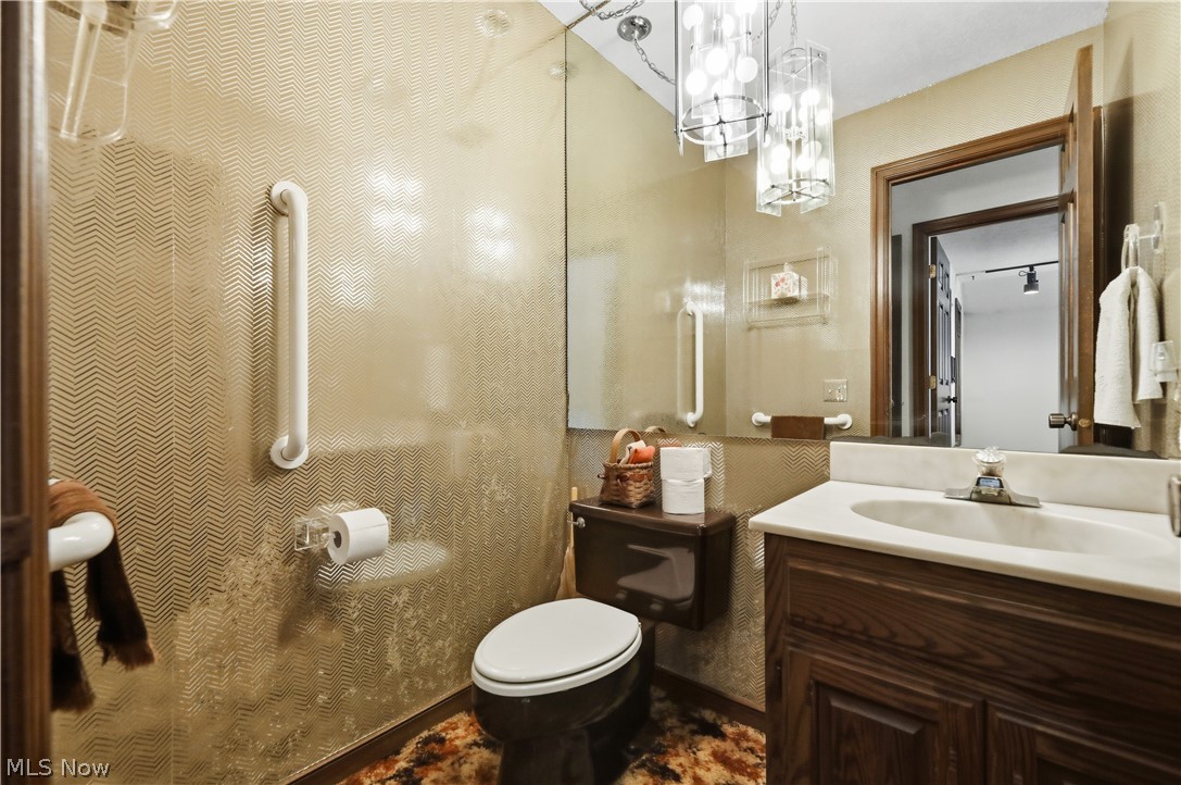 7014 River Styx Road Medina, OH 44256 - Photo 24 of 50 Half bathroom with vanity and a chandelier
