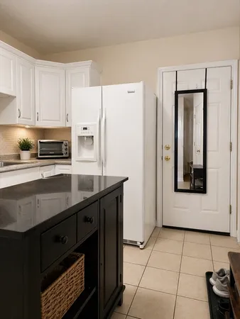 a kitchen with stainless steel appliances a refrigerator sink and cabinets