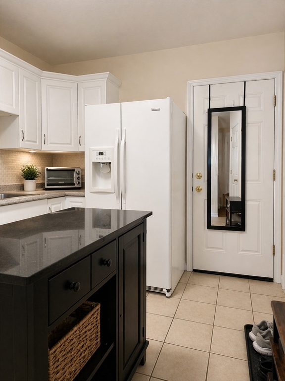 a kitchen with stainless steel appliances a refrigerator sink and cabinets