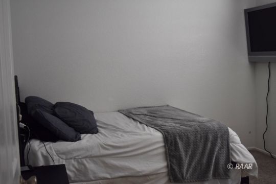 516 South Sorrel Street Ridgecrest, CA 93555 - Photo 22 of 32 a bed sitting in a bedroom next to a tv on a bed