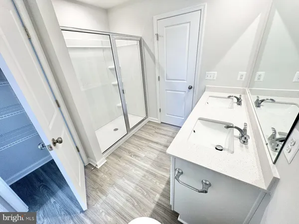 a bathroom with a sink a mirror and a shower