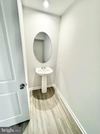 a bathroom with a sink toilet and a mirror