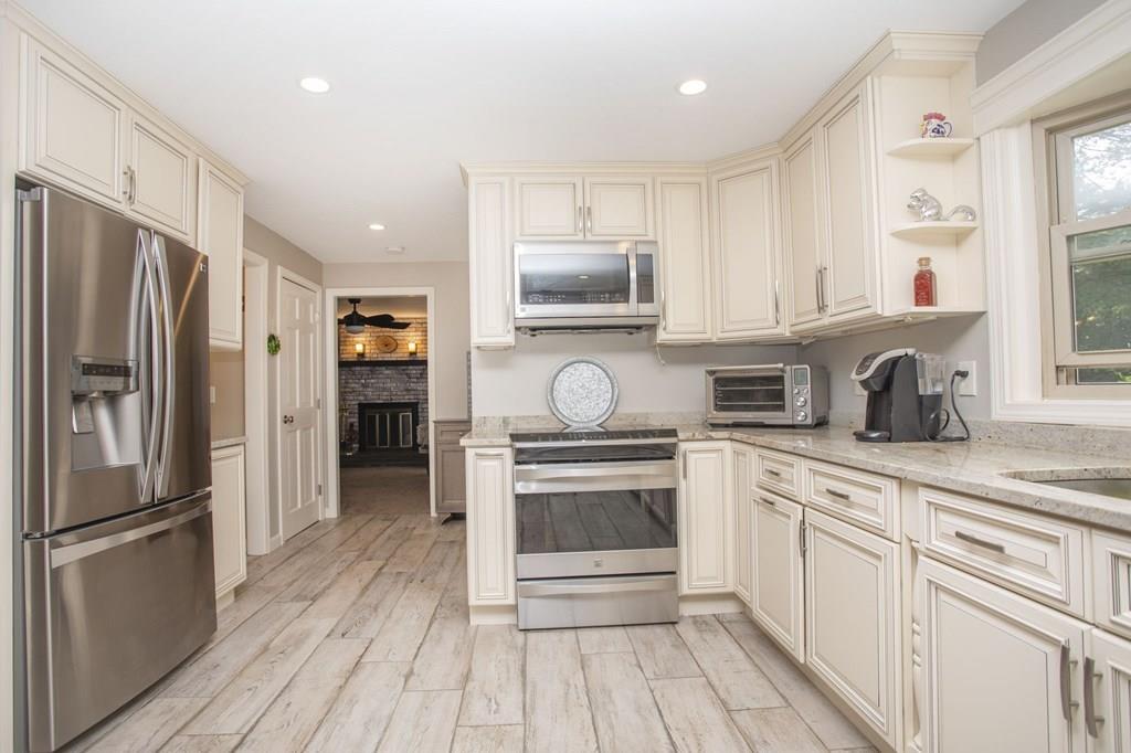 344 Walnut Plain Road Rochester, MA 02770 - Photo 11 of 42 a kitchen with granite countertop a refrigerator stove and sink