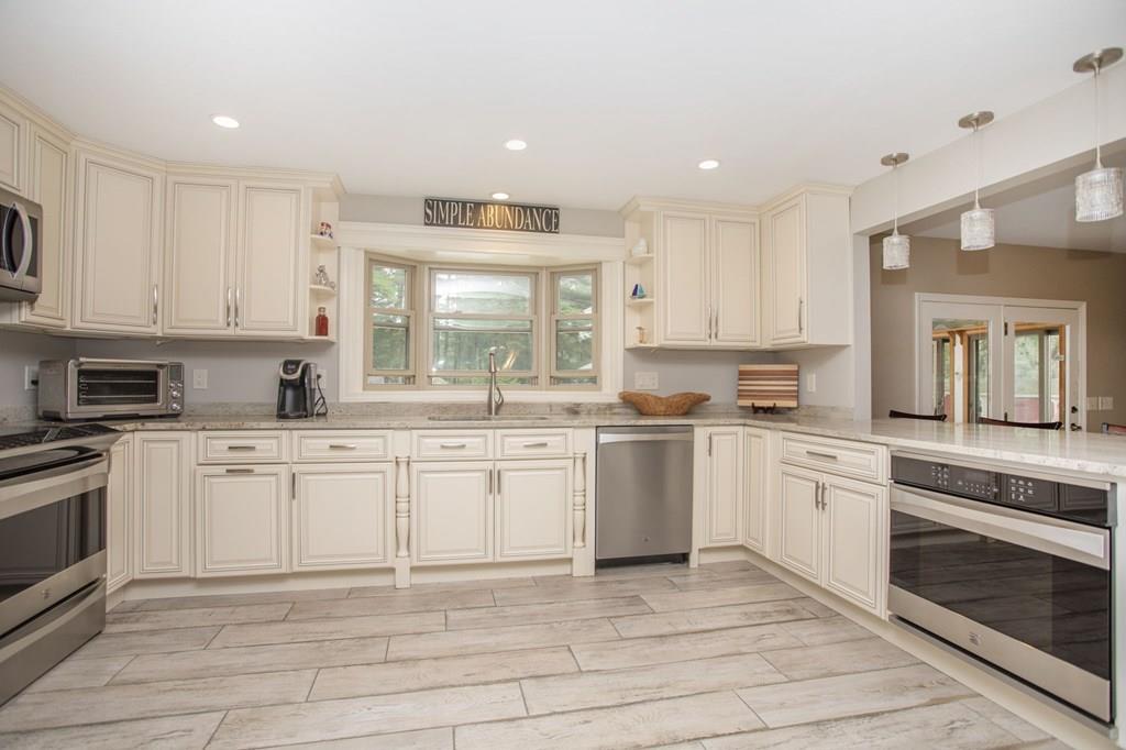 344 Walnut Plain Road Rochester, MA 02770 - Photo 12 of 42 a kitchen with granite countertop white cabinets white appliances a sink and a window