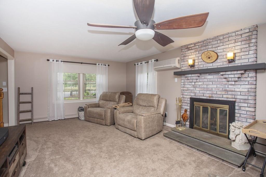 344 Walnut Plain Road Rochester, MA 02770 - Photo 20 of 42 a living room with furniture and a fireplace