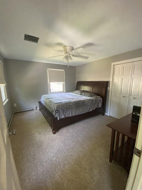 344 Walnut Plain Road Rochester, MA 02770 - Photo 27 of 42 a bedroom with a bed and a chandelier