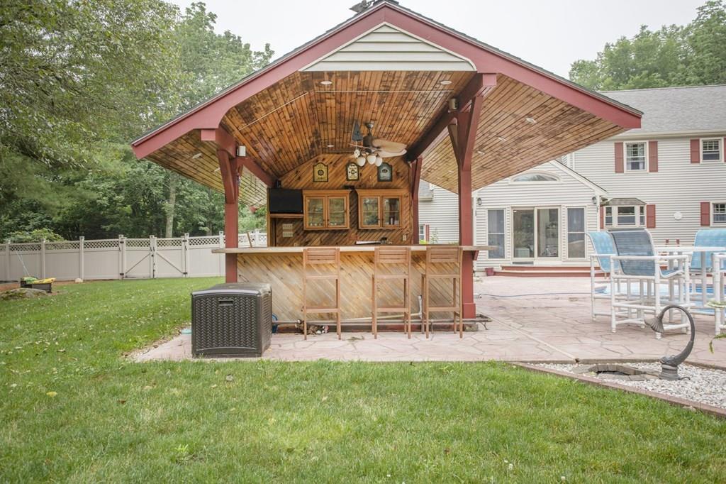 344 Walnut Plain Road Rochester, MA 02770 - Photo 4 of 42 a view of a house with a backyard and a patio