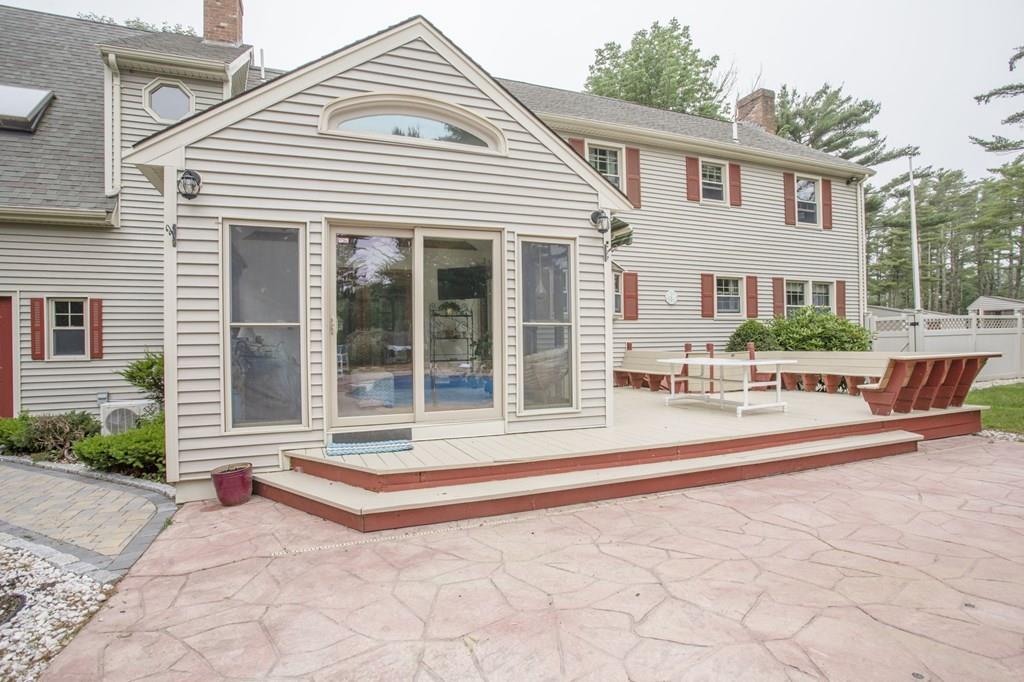 344 Walnut Plain Road Rochester, MA 02770 - Photo 6 of 42 a view of a white house with a patio