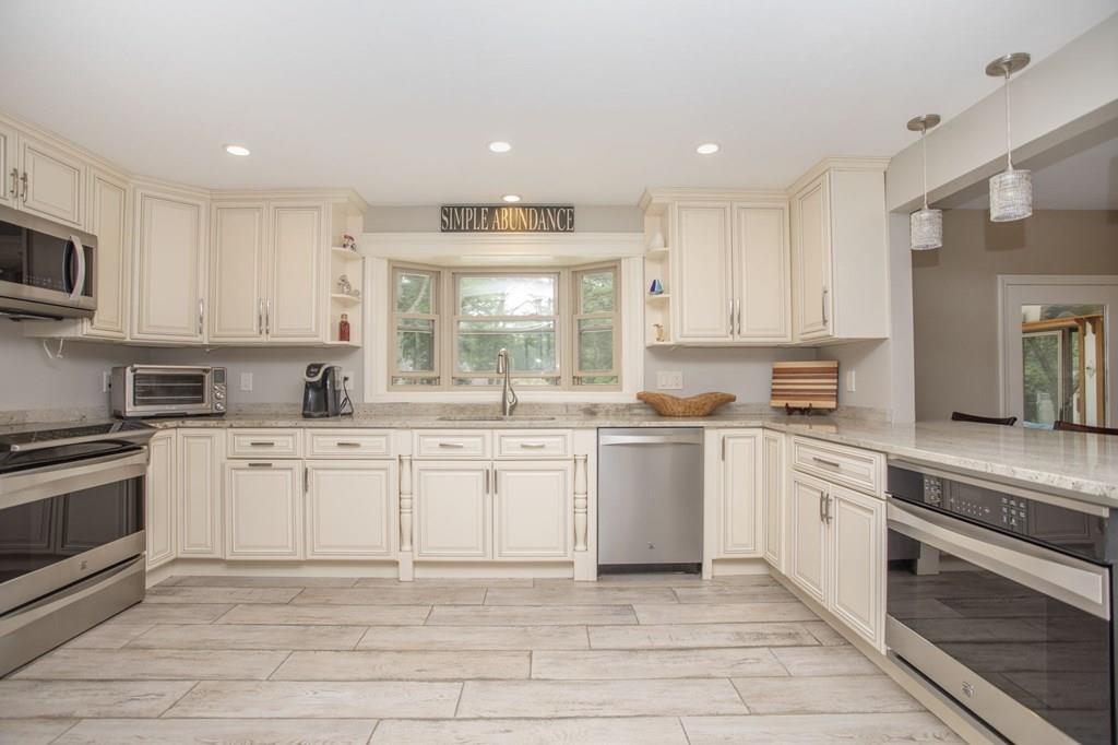 344 Walnut Plain Road Rochester, MA 02770 - Photo 7 of 42 a kitchen with granite countertop white cabinets white stainless steel appliances with a sink and dishwasher