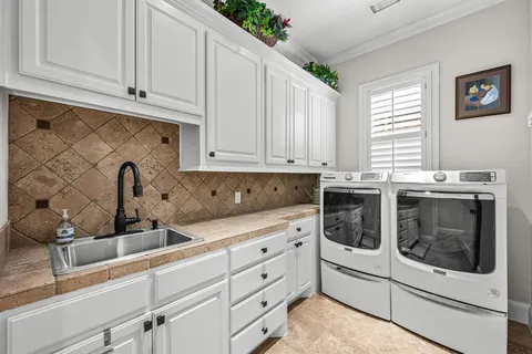a kitchen with granite countertop white cabinets and white appliances