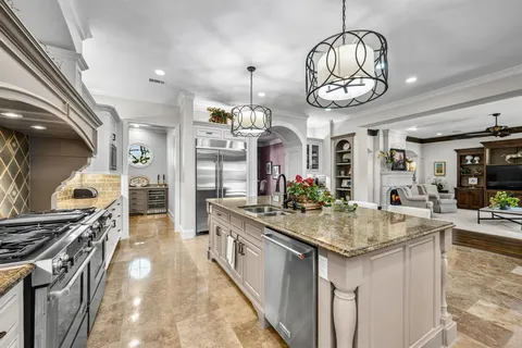 a kitchen with stove and cabinets