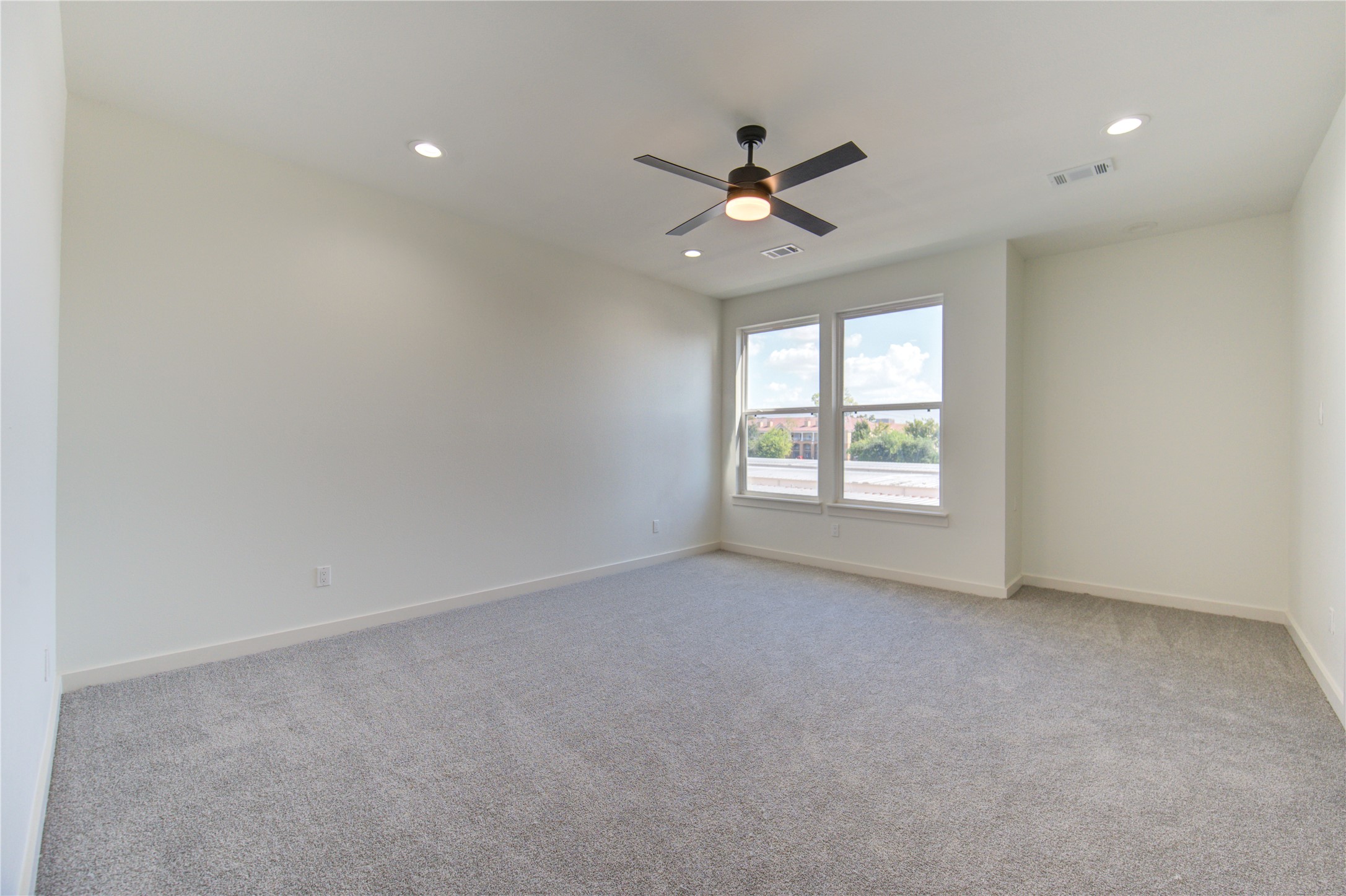 2912 El Fenice Lane Houston, TX 77057 - Photo 15 of 49 an empty room with a window and a fan