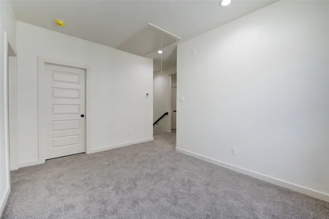 an empty room with an entrance to other room