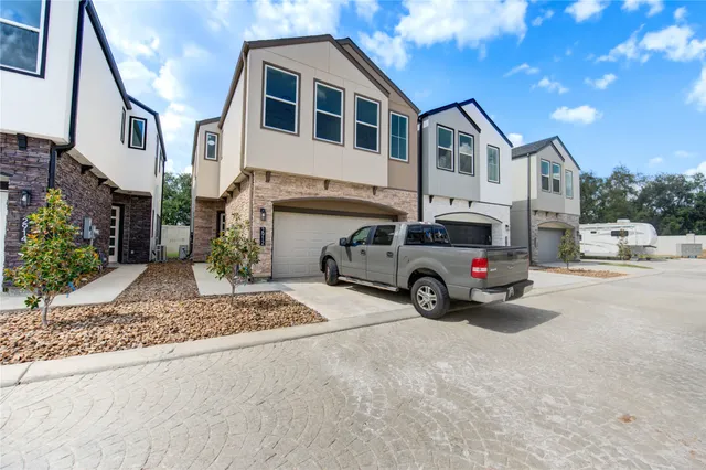 a car parked in front of a white house