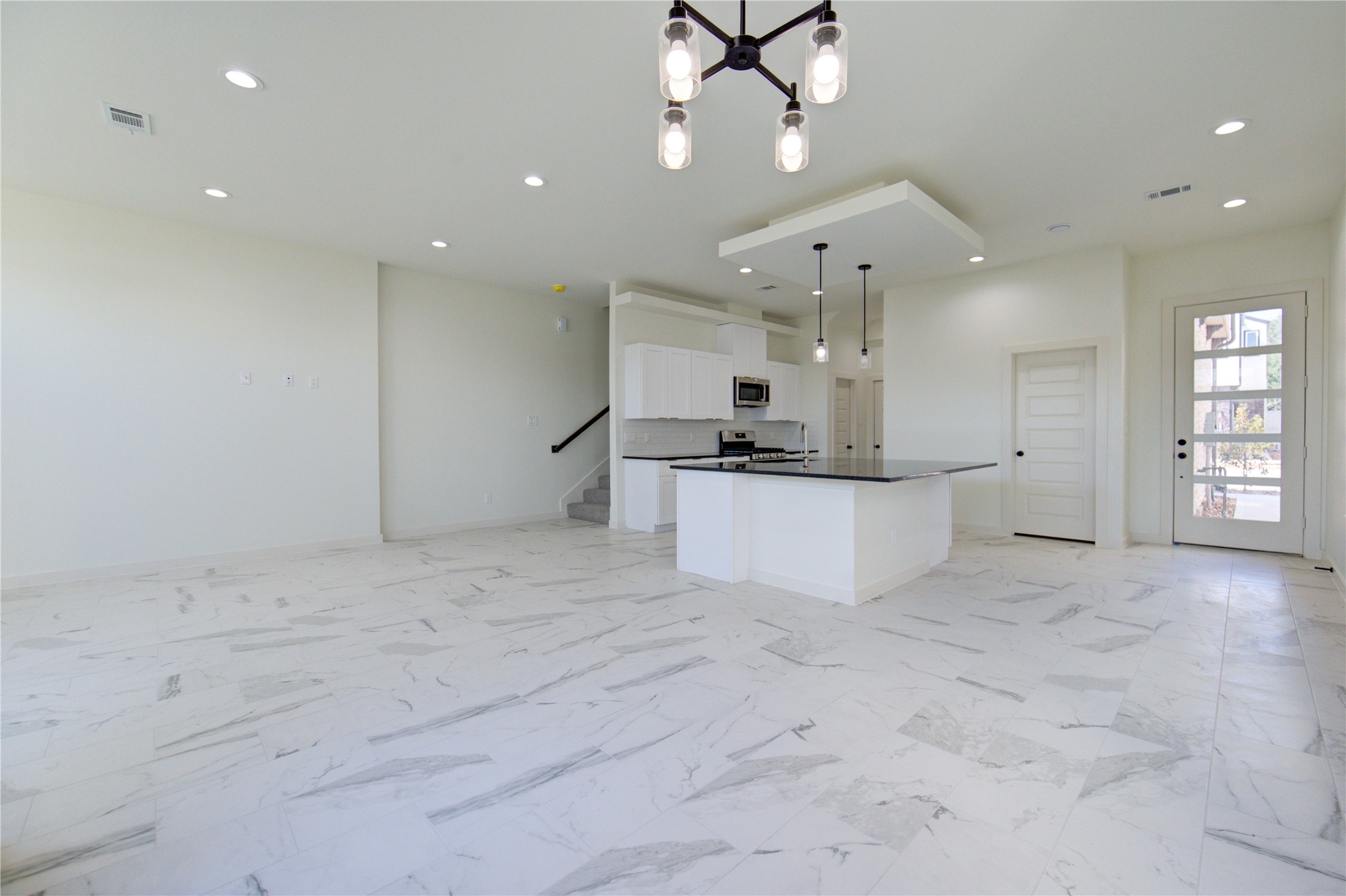 2912 El Fenice Lane Houston, TX 77057 - Photo 30 of 49 a large white kitchen with cabinets and wooden floor