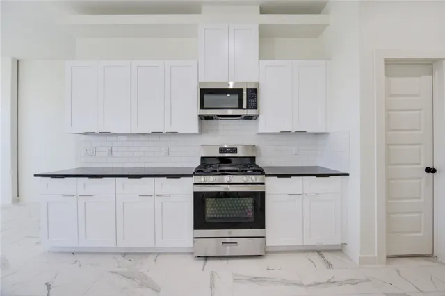 a kitchen with a large counter space and a window