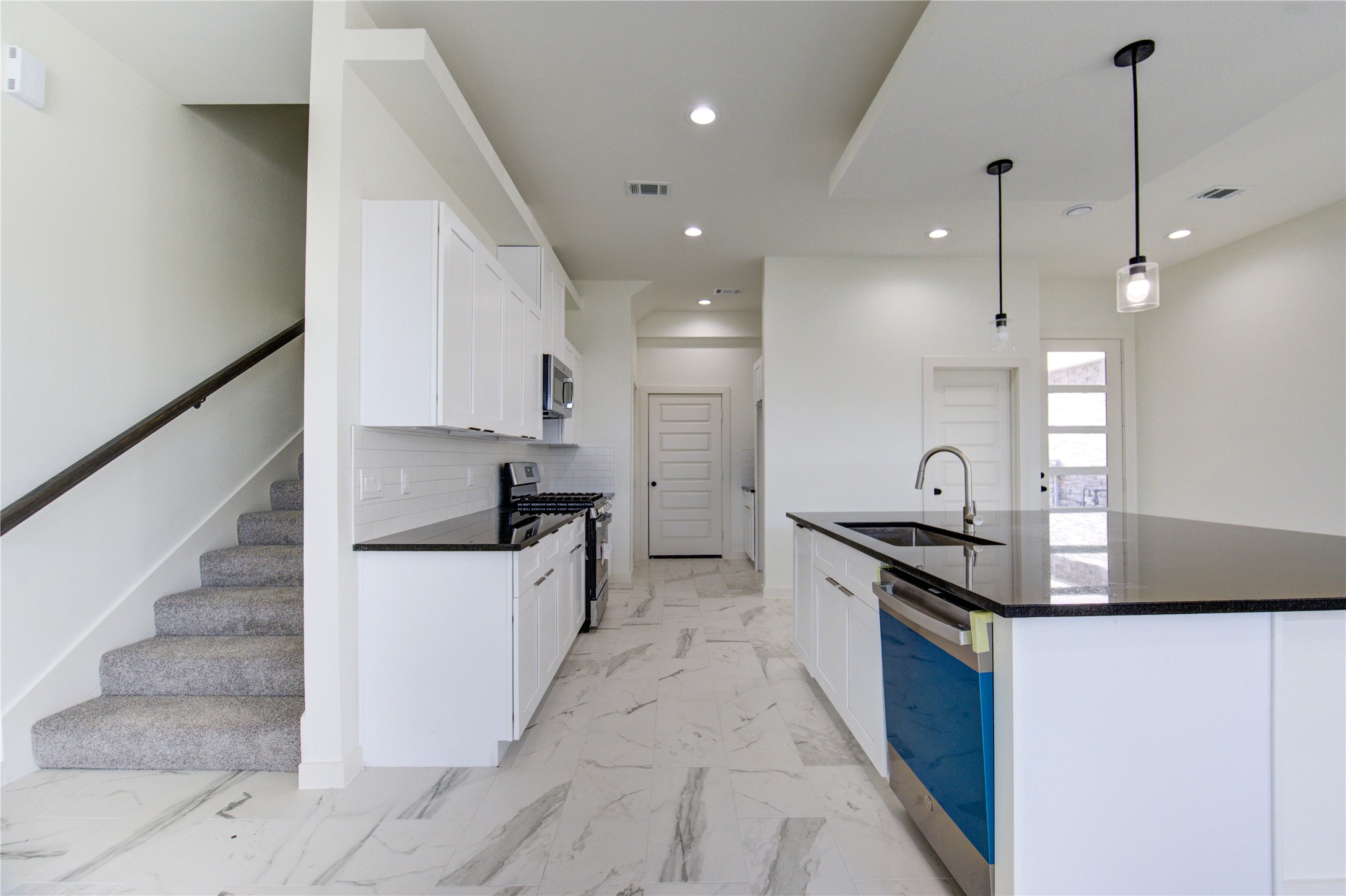 2912 El Fenice Lane Houston, TX 77057 - Photo 39 of 49 a kitchen with granite countertop a stove a sink and a refrigerator