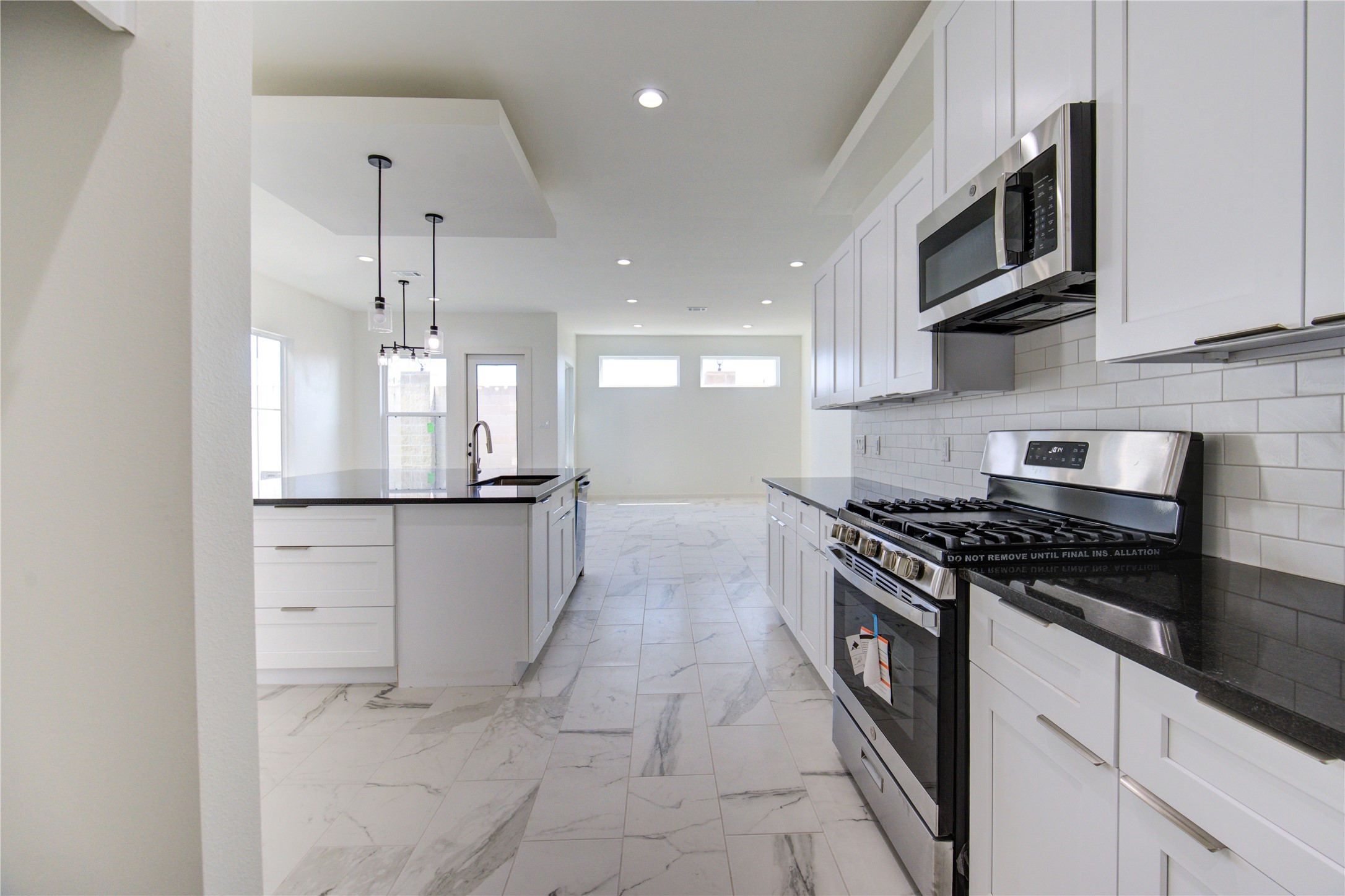 2912 El Fenice Lane Houston, TX 77057 - Photo 4 of 49 a kitchen with stainless steel appliances granite countertop a stove a refrigerator and a microwave