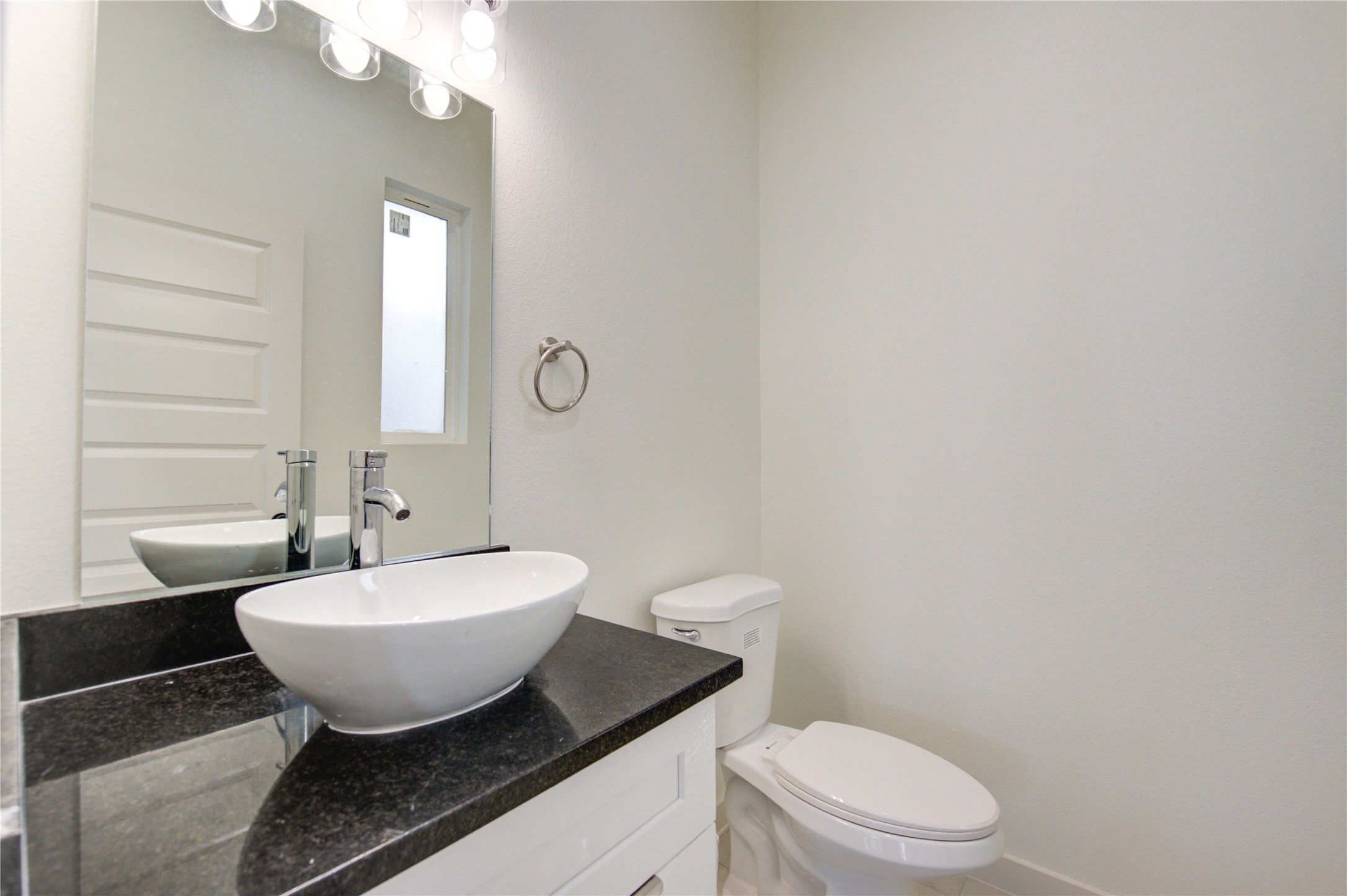2912 El Fenice Lane Houston, TX 77057 - Photo 45 of 49 a bathroom with a toilet a sink and mirror