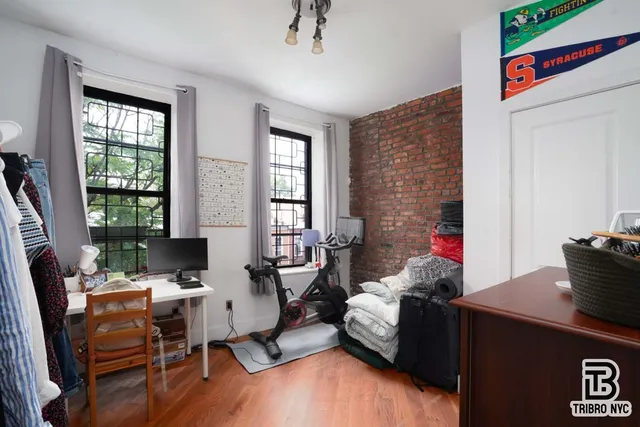 a living room with furniture and large windows