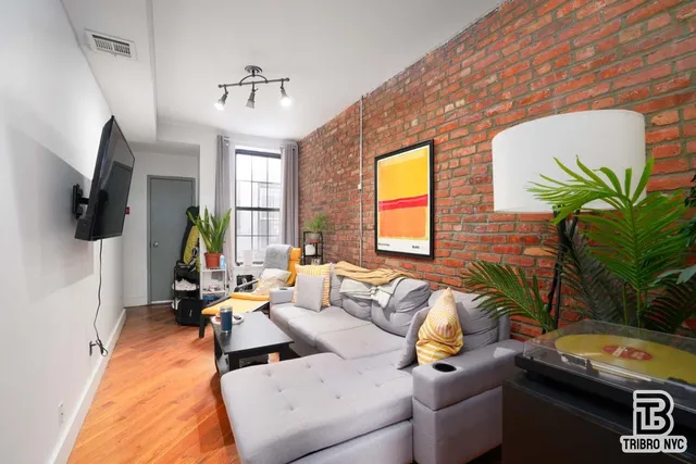 a living room with furniture fireplace and a flat screen tv