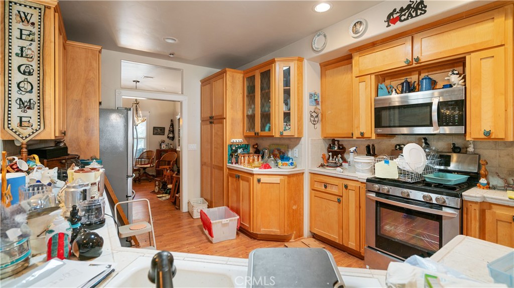 22070 Big Oak Road Cedarpines Park, CA 92322 - Photo 15 of 58 a kitchen with stainless steel appliances granite countertop a sink and cabinets