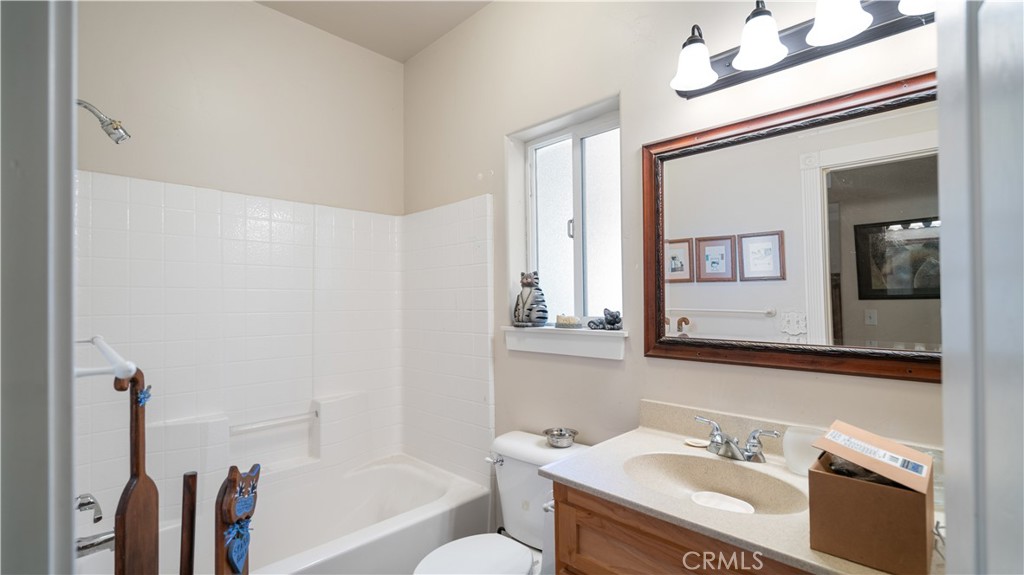 22070 Big Oak Road Cedarpines Park, CA 92322 - Photo 41 of 58 a bathroom with a sink vanity granite tub and a mirror