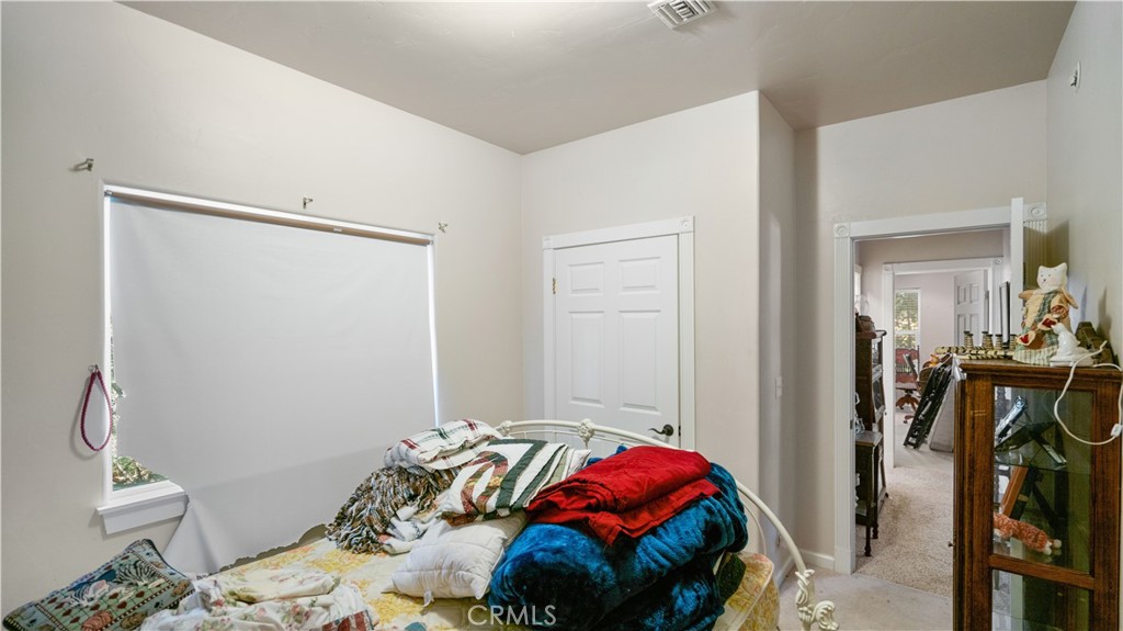 22070 Big Oak Road Cedarpines Park, CA 92322 - Photo 42 of 58 a bedroom with a bed and a mirror