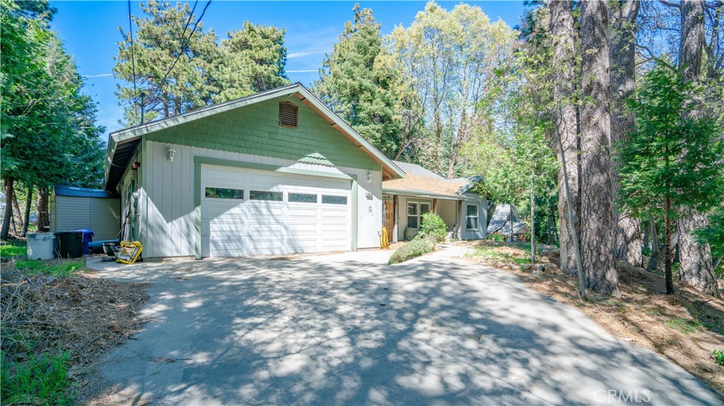 22070 Big Oak Road Cedarpines Park, CA 92322 - Photo 48 of 58 a front view of a house with a yard and garage