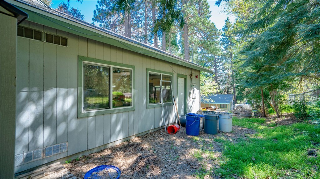 22070 Big Oak Road Cedarpines Park, CA 92322 - Photo 49 of 58 a view of backyard with table and chairs and potted plants