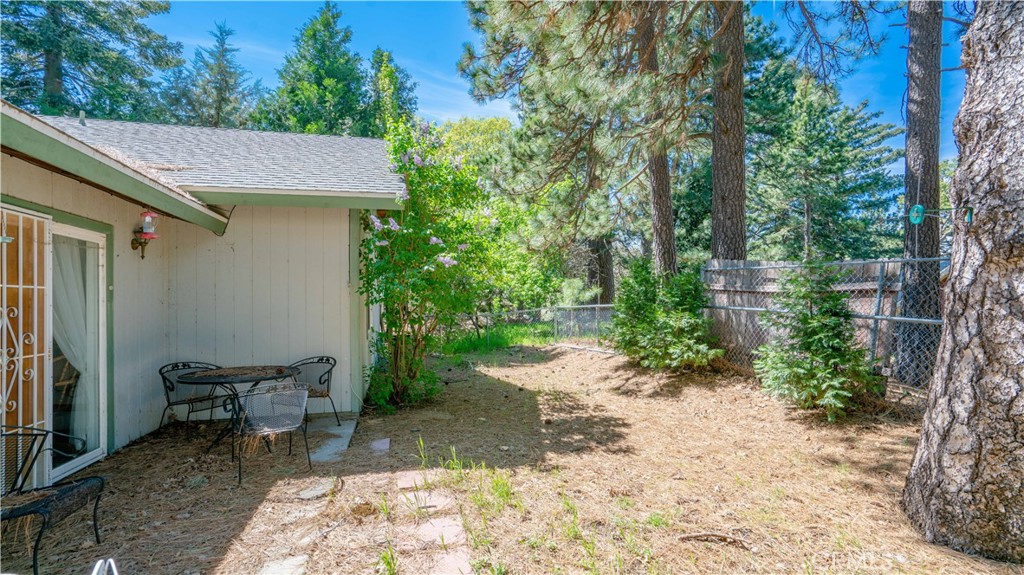 22070 Big Oak Road Cedarpines Park, CA 92322 - Photo 54 of 58 a view of a patio with table and chairs and potted plants