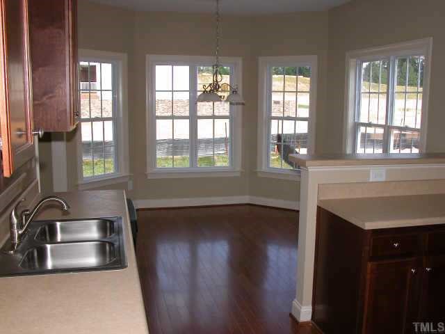 152 Sharp Top Trail Apex, NC 27502 - Photo 8 of 10 a kitchen with a sink a counter top space and a window