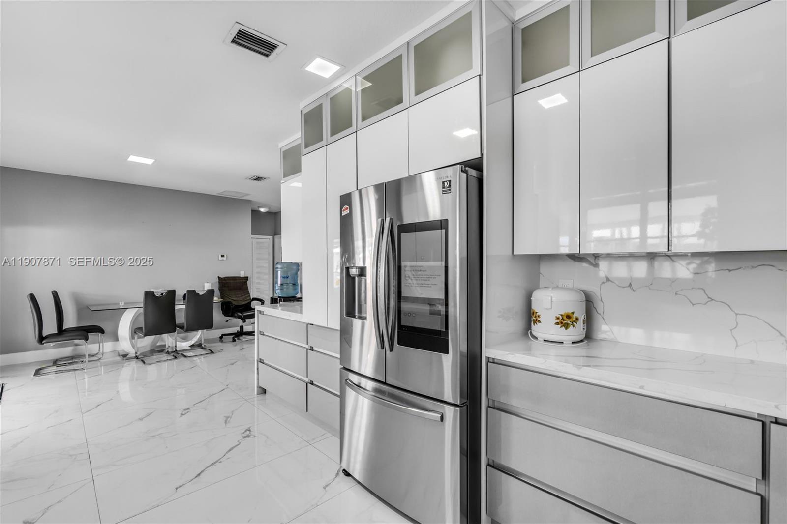 13381 Southwest 269th Street Homestead, FL 33032 - Photo 16 of 44 a kitchen with stainless steel appliances a refrigerator sink and cabinets