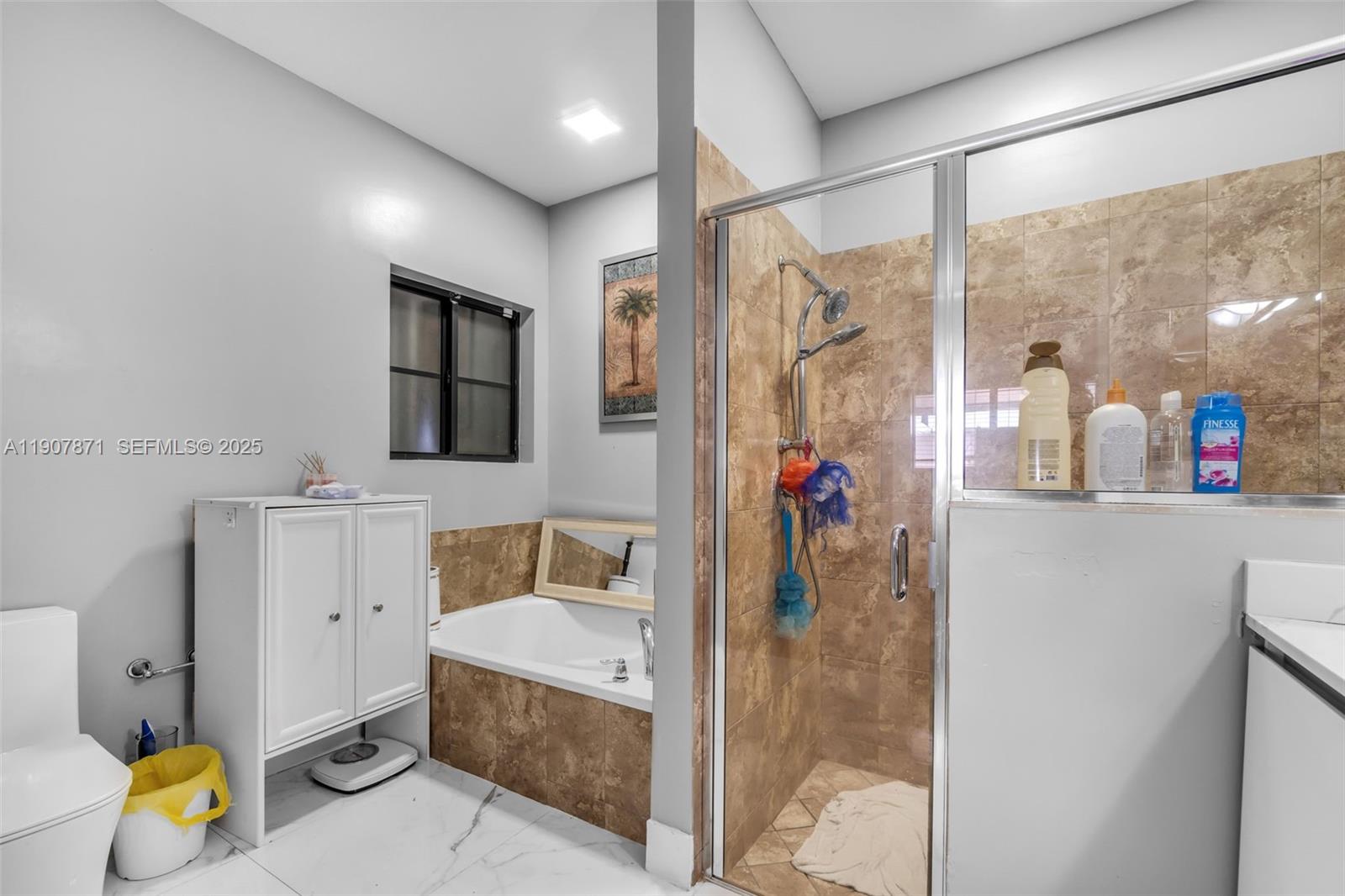 13381 Southwest 269th Street Homestead, FL 33032 - Photo 22 of 44 a bathroom with a tub shower and sink
