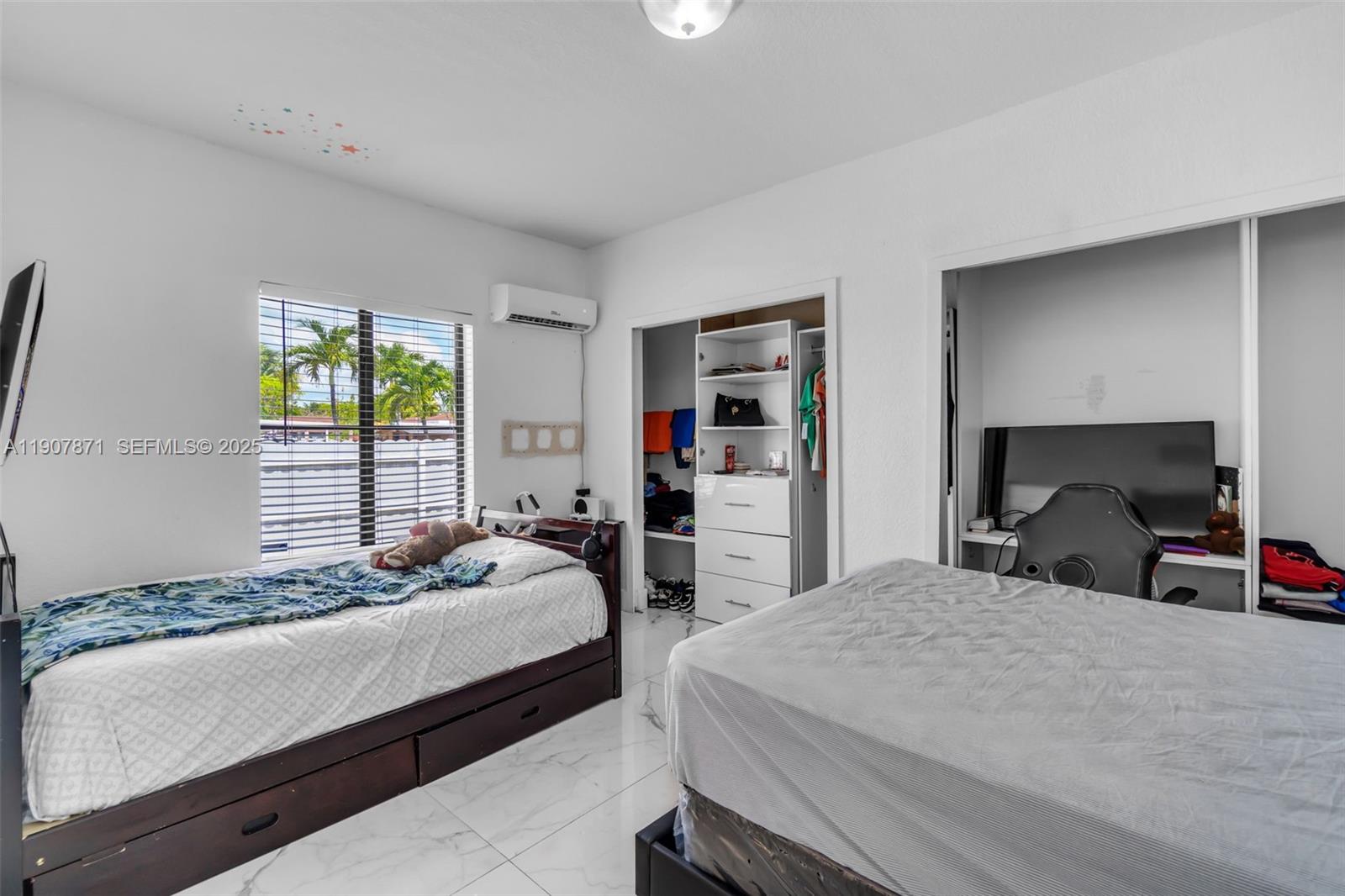 13381 Southwest 269th Street Homestead, FL 33032 - Photo 28 of 44 a bedroom with a bed and a large window