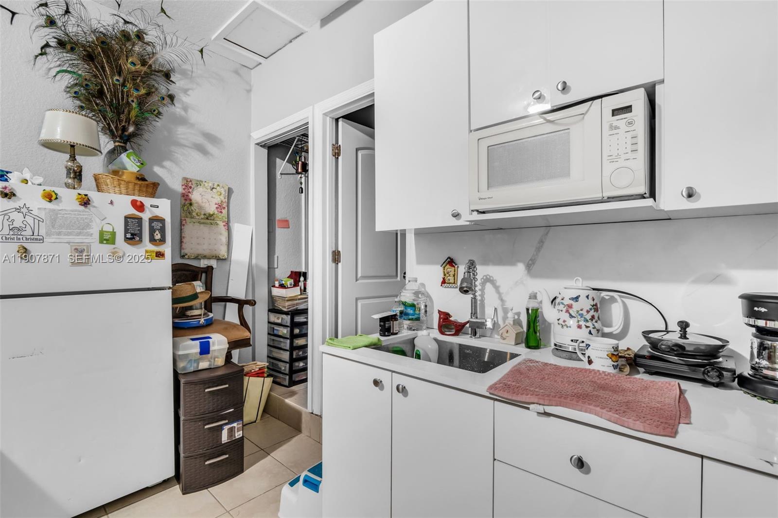 13381 Southwest 269th Street Homestead, FL 33032 - Photo 32 of 44 a kitchen with appliances a sink and cabinets
