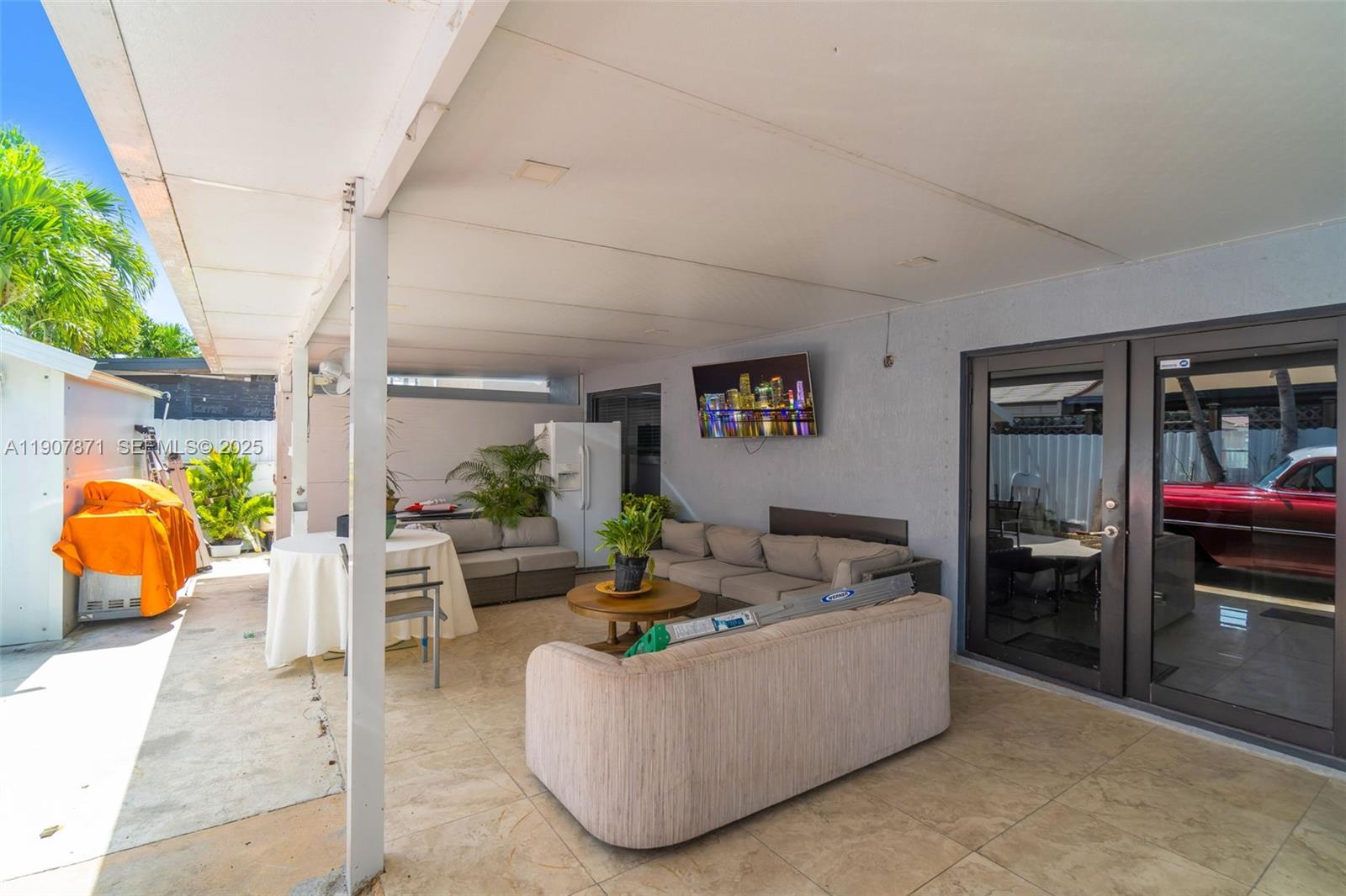 13381 Southwest 269th Street Homestead, FL 33032 - Photo 34 of 44 a living room with furniture and a flat screen tv