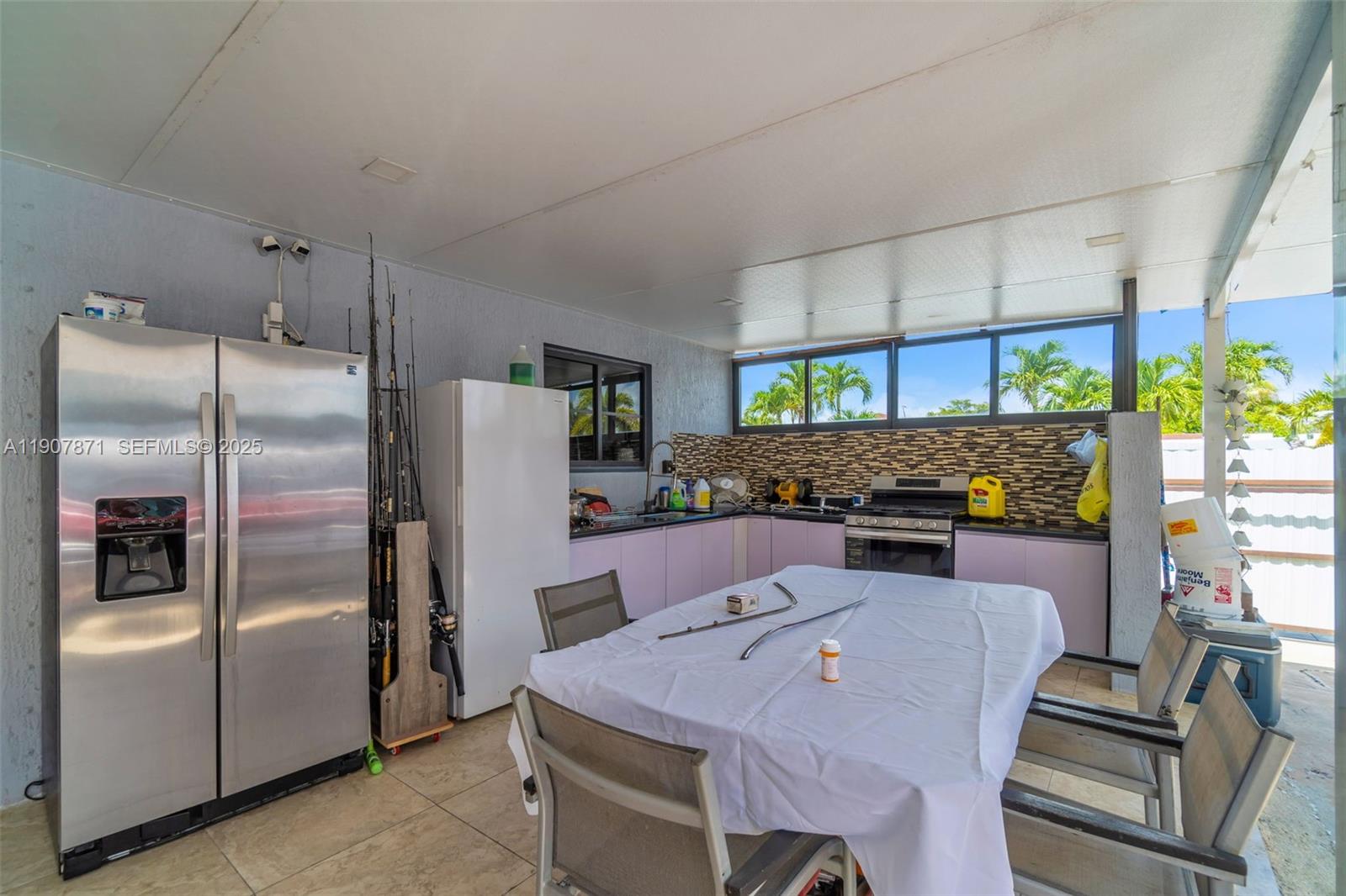 13381 Southwest 269th Street Homestead, FL 33032 - Photo 37 of 44 a dining table chair and a refrigerator