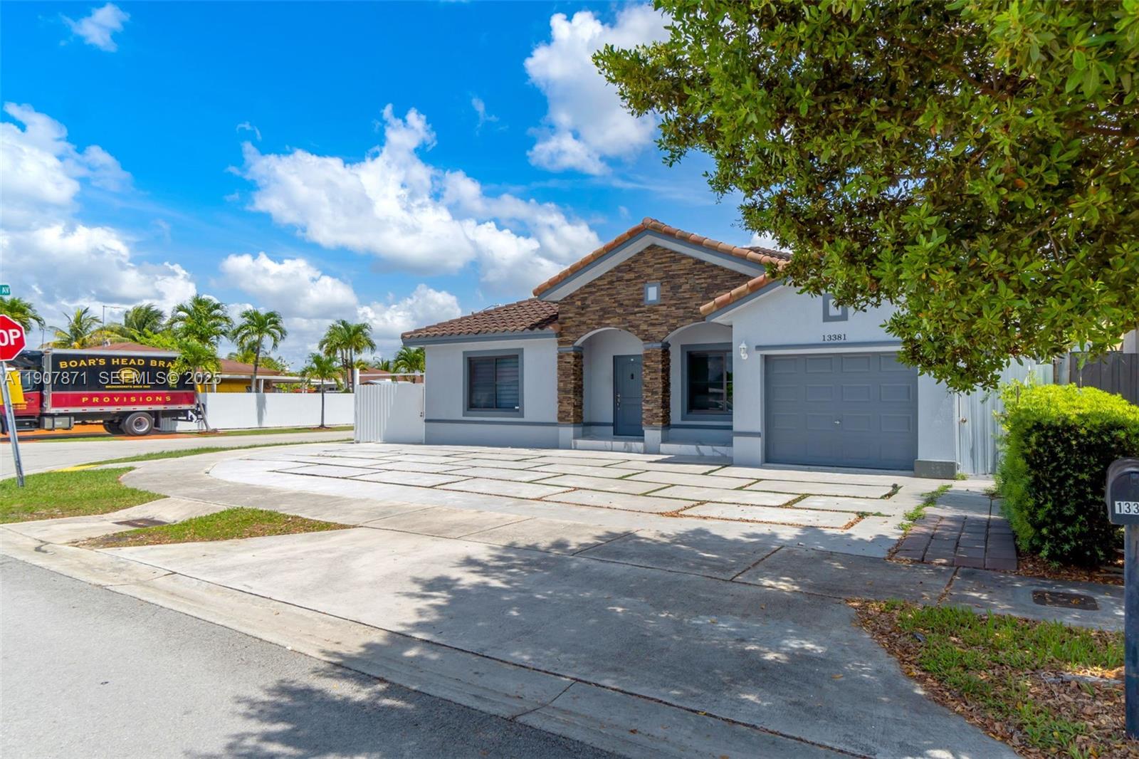 13381 Southwest 269th Street Homestead, FL 33032 - Photo 7 of 44 a front view of a house with a yard and garage