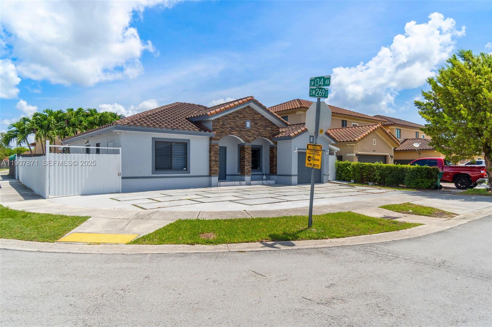 13381 Southwest 269th Street Homestead, FL 33032 - Photo 8 of 44 a front view of a house with a yard and garage