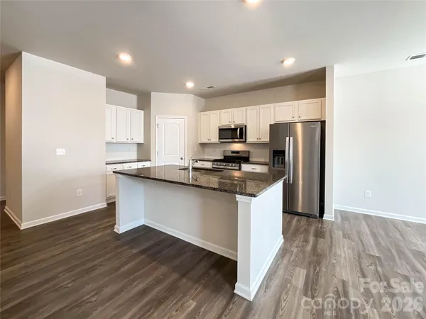 a view of kitchen with a sink and a stove top oven